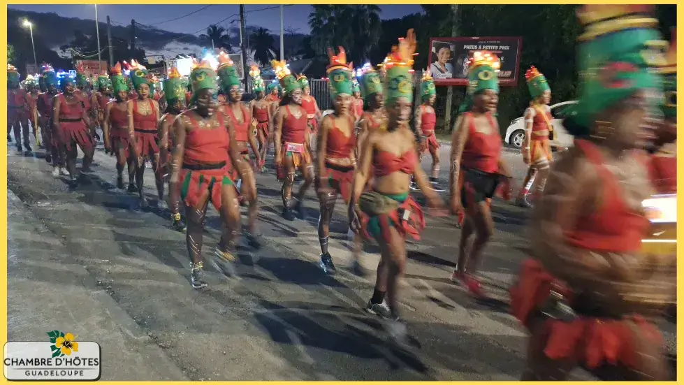 Danseurs en costumes traditionnels colorés lors de la parade du dimanche gras, illustrant la richesse culturelle de la Guadeloupe à découvrir entre janvier et avril.